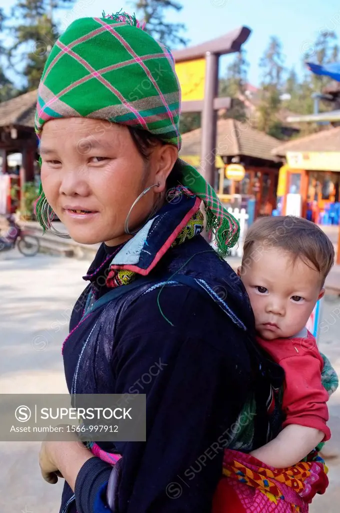 Black Hmong woman carrying baby on her back, Sapa, North Vietnam