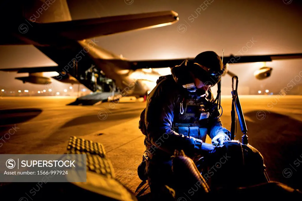 3/17/2011 - Tech  Sgt  Ray Decker, 320th Special Tactics Squadron, prepares his rucksack prior to boarding an MC-130P Combat Shadow here March 16  Mem...