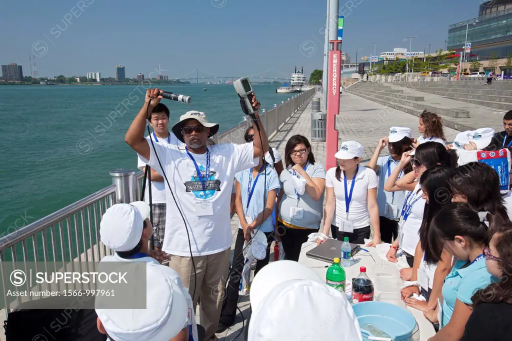 Detroit, Michigan - Sixth grade students learn about water quality at the Detroit River Water Festival  Here a teacher displays a meter they will use ...
