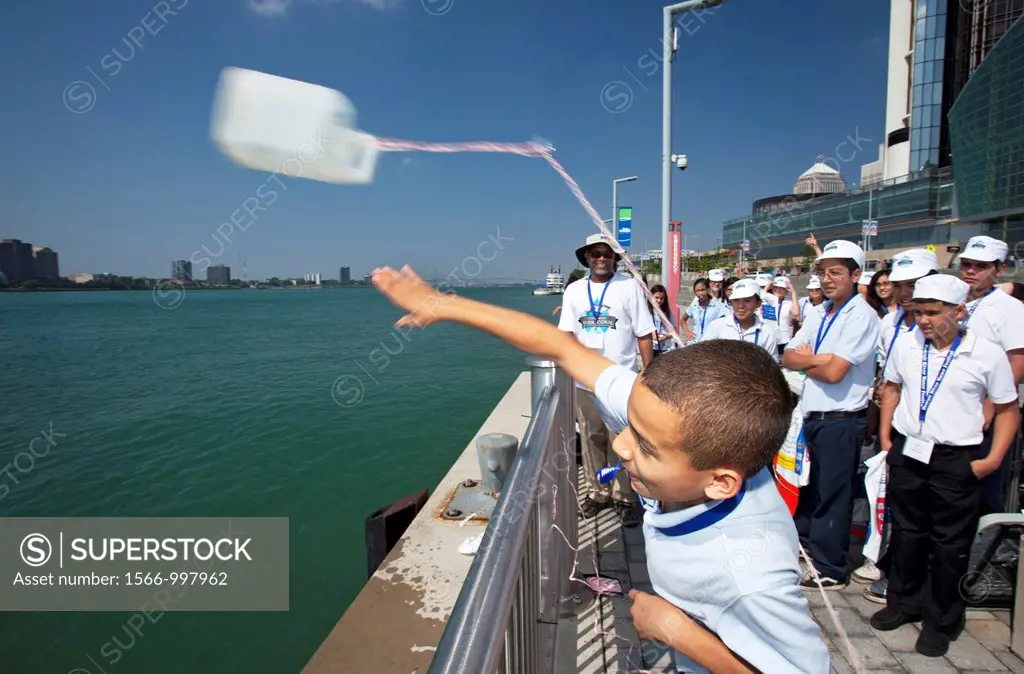 Detroit, Michigan - Sixth grade students learn about water quality at the Detroit River Water Festival  Here they throw a container into the Detroit R...