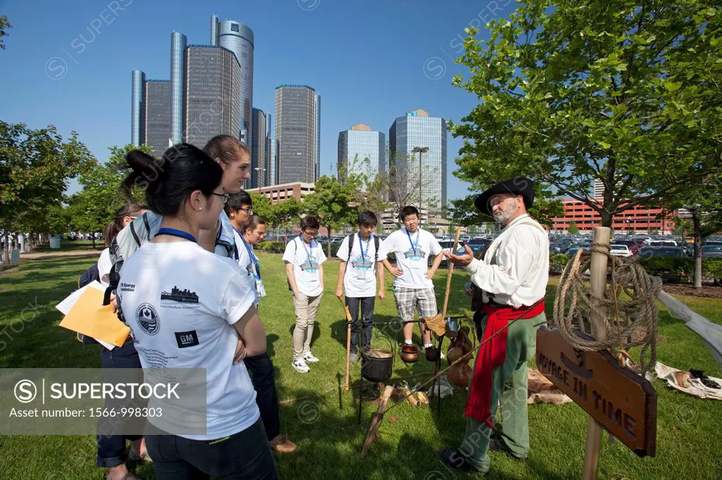 Detroit, Michigan - Students learn about the pioneers who settled Detroit at the Detroit River Water Festival  In the background is the General Motors...