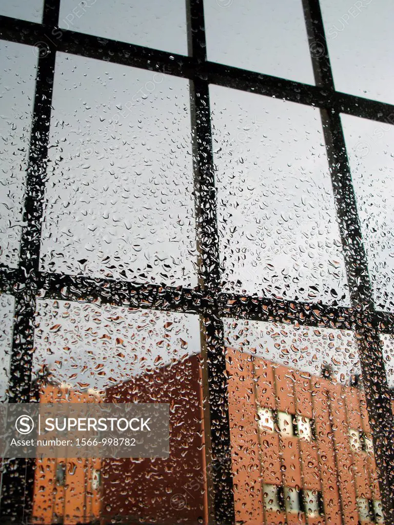 modern office block seen through rain drops covered window