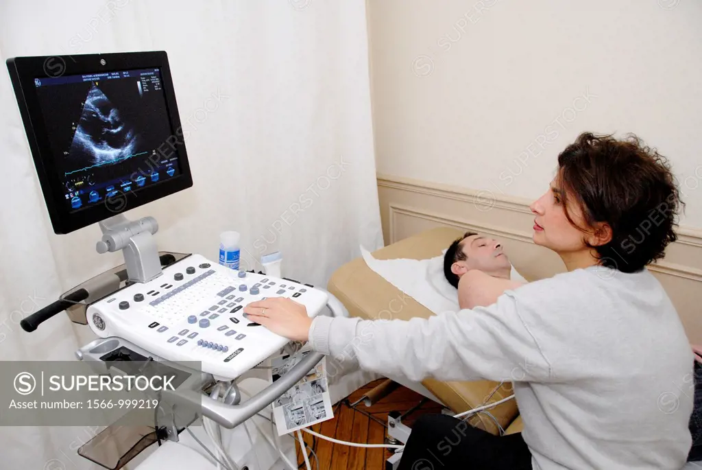 Cardiology exam Echocardiography  Middle aged patient undergoing an abdominal ultrasound scan  A transducer held against his abdomen emits ultrasonic ...