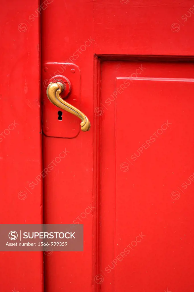 red door with curved brass handle - shot straight on