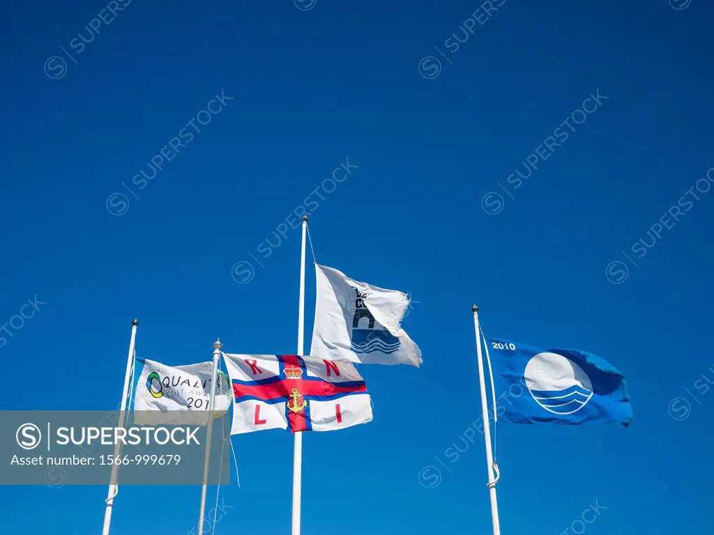 Various flags flying over Westward Ho! beach, Devon, England, United Kingdom