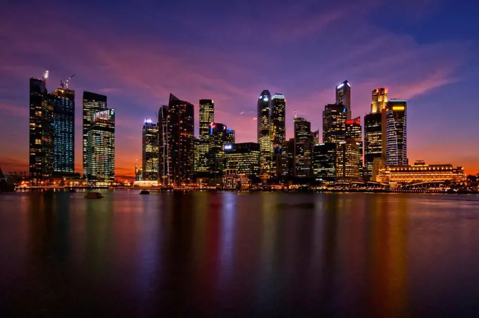 A view of the Singapore Central Business District and skyline at dusk, viewed from the Marina Bay Sands integrated resort
