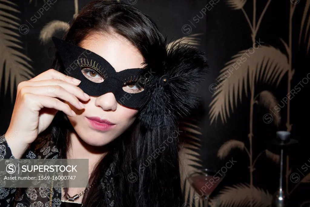 Woman wearing party mask, portrait