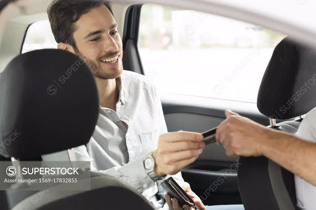 Young man making payment through credit card