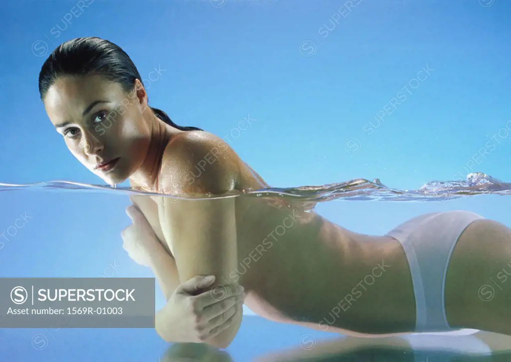 Semi-nude woman in water looking at camera