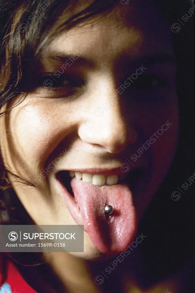 Young woman showing tongue piercing