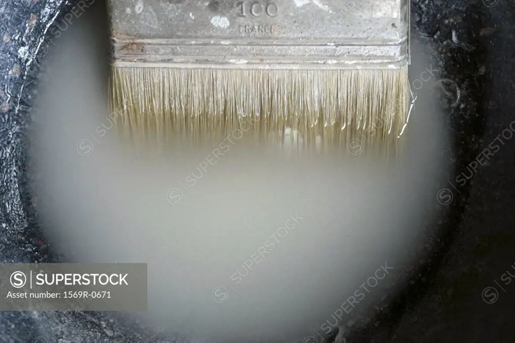 Paintbrush soaking in turpentine, close-up