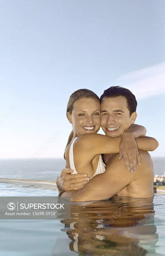 Young couple embracing in pool