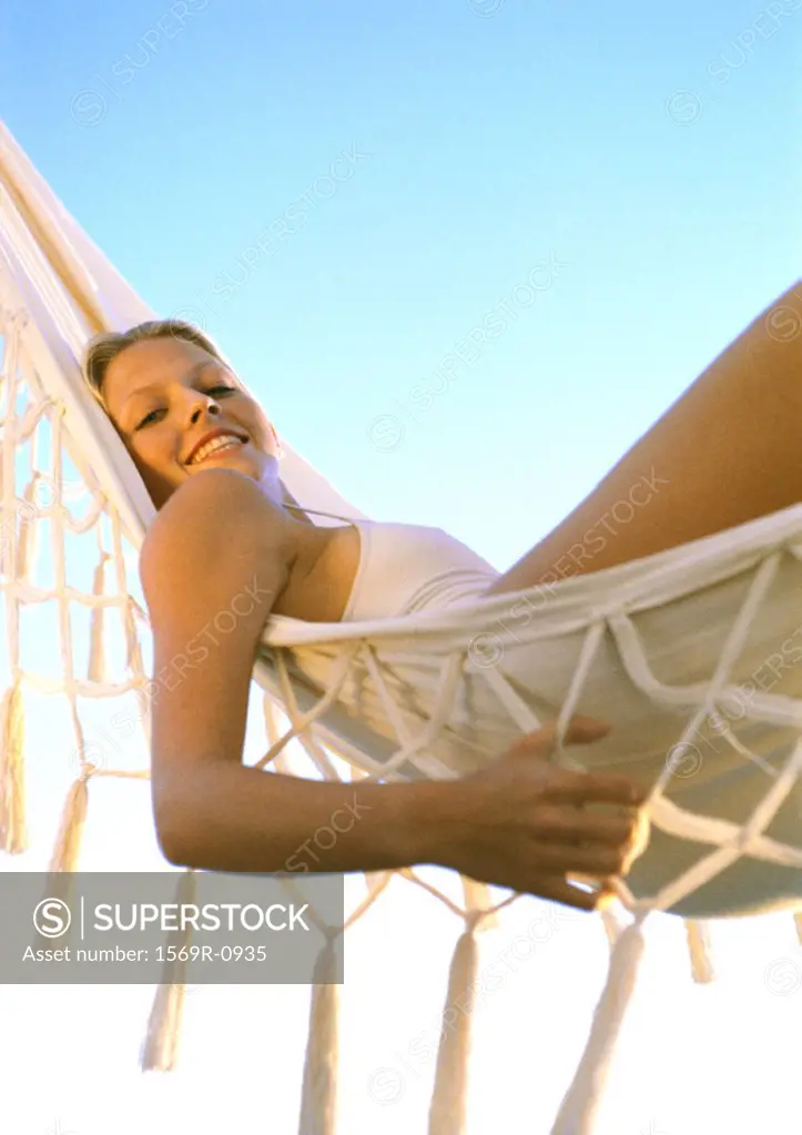 Young woman lying in hammock