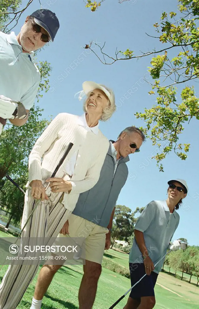 Mature golfers walking side by side