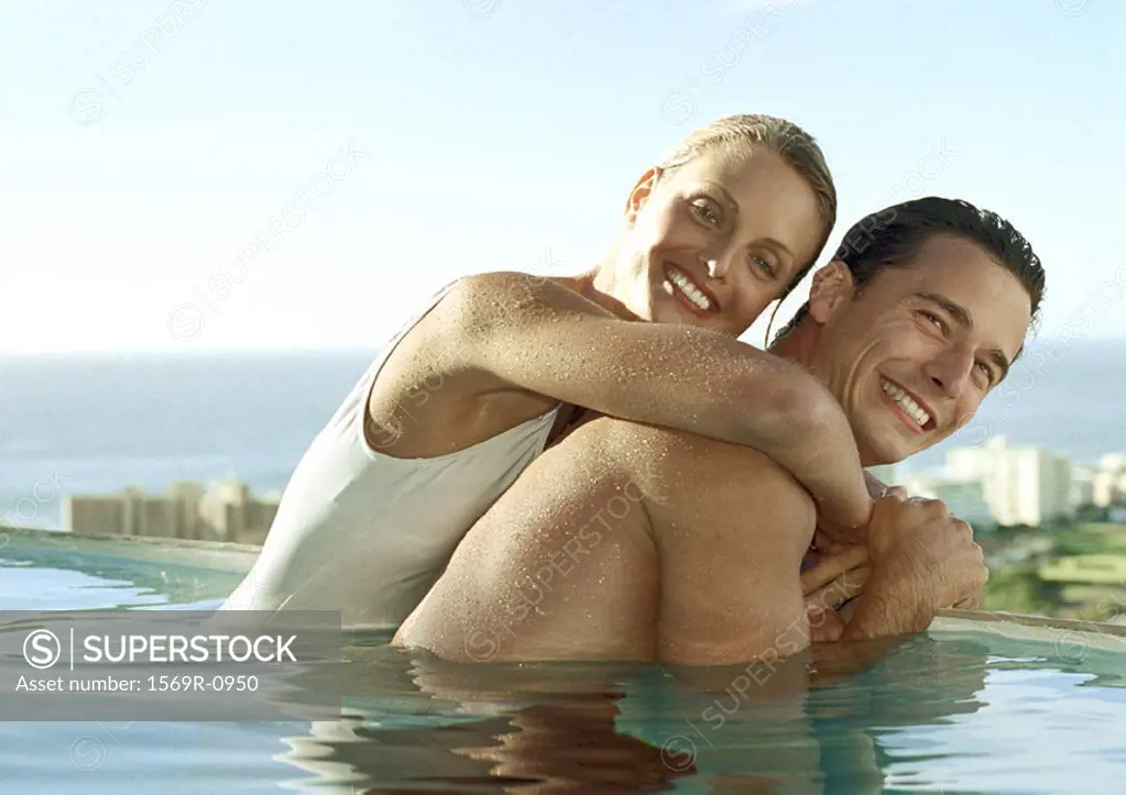 Young couple embracing in pool