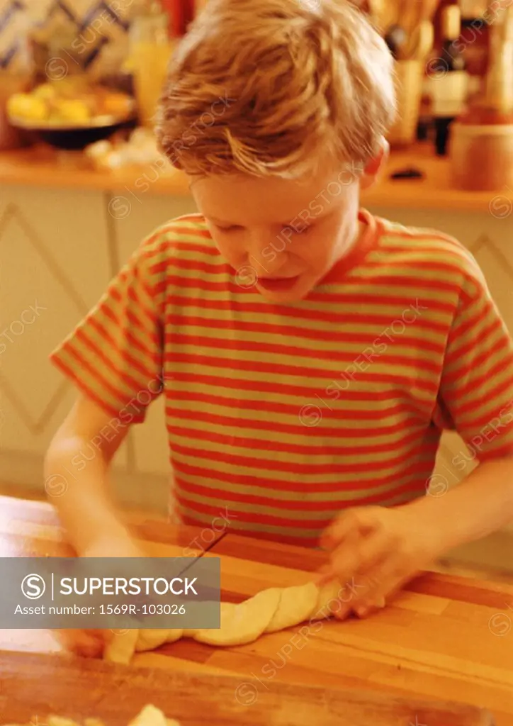 Child handling pastry dough, blurred motion