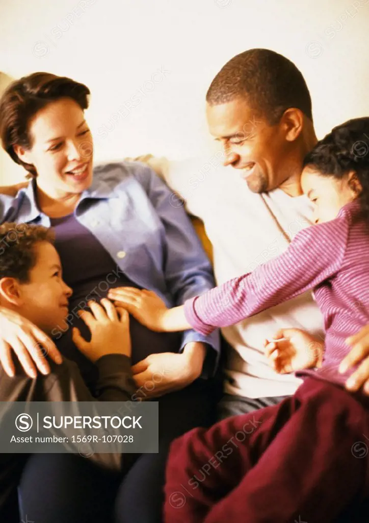 Couple sitting with children, smiling