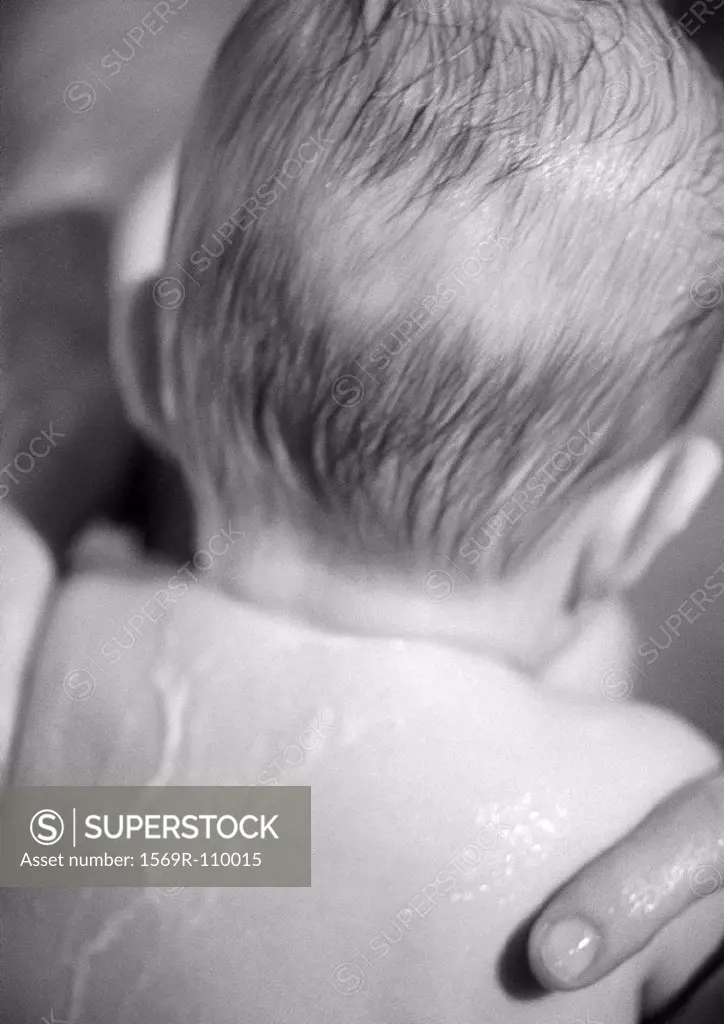 Baby with wet hair and back, rear view, close-up, b&w