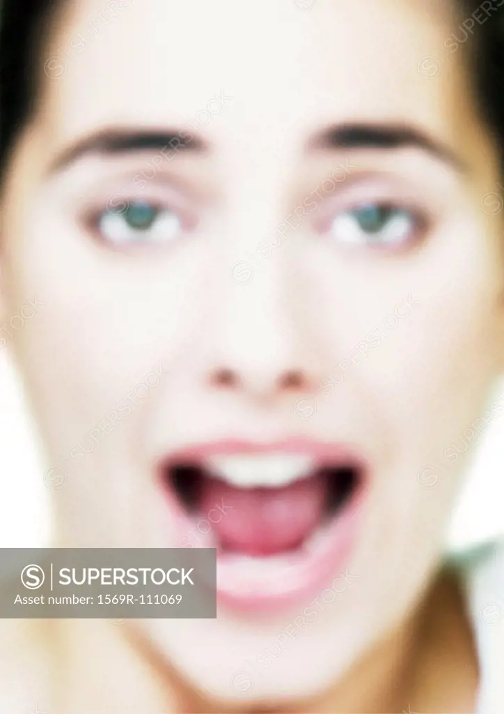 Woman´s face, mouth open, close-up, blurred