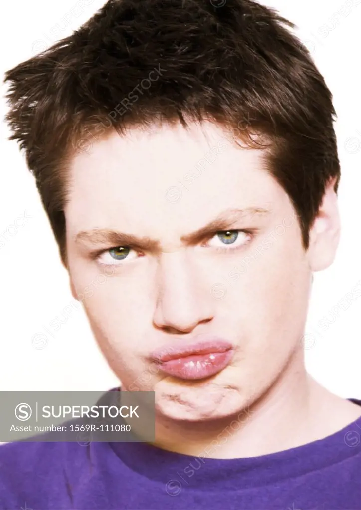Teenage boy making face, close-up, portrait