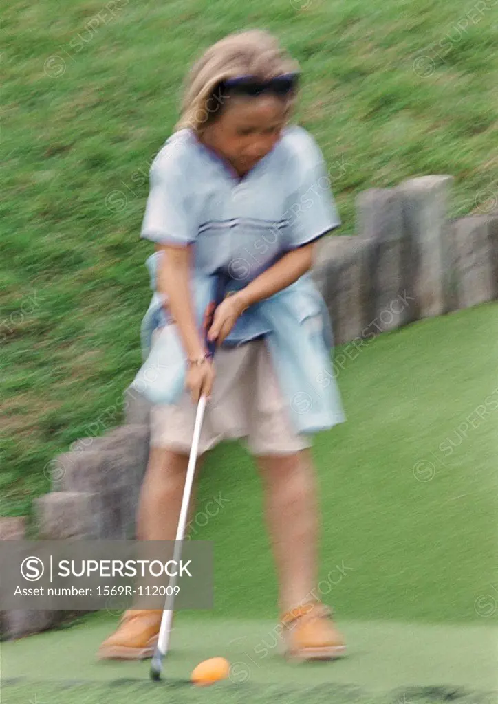 Girl playing golf, blurred