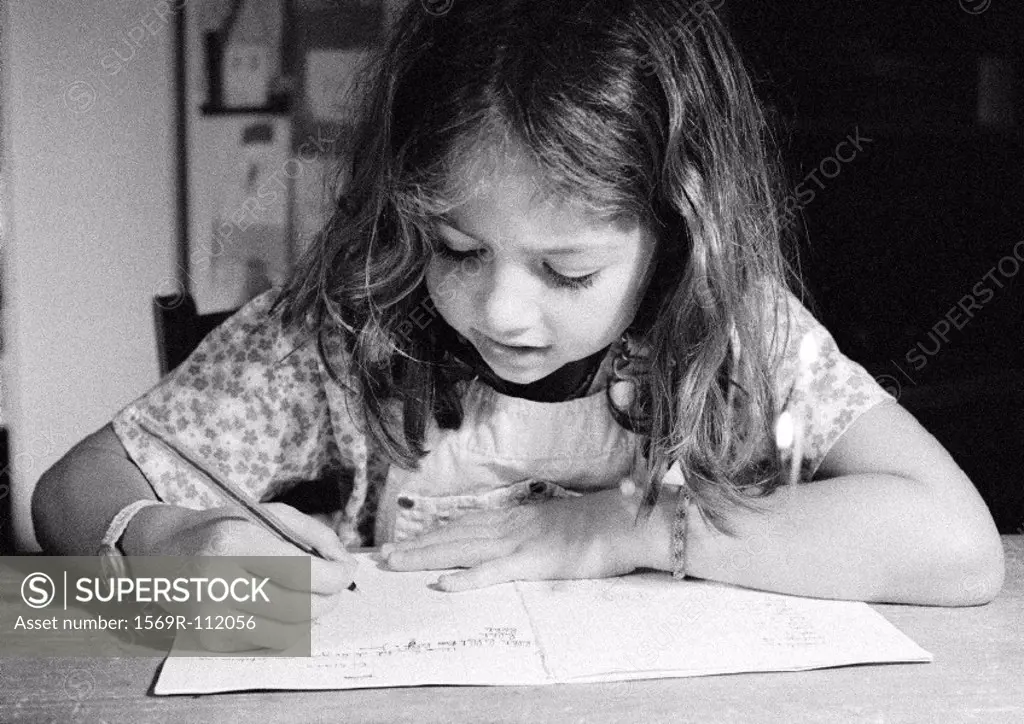 Girl writing in notebook, close-up, b&w
