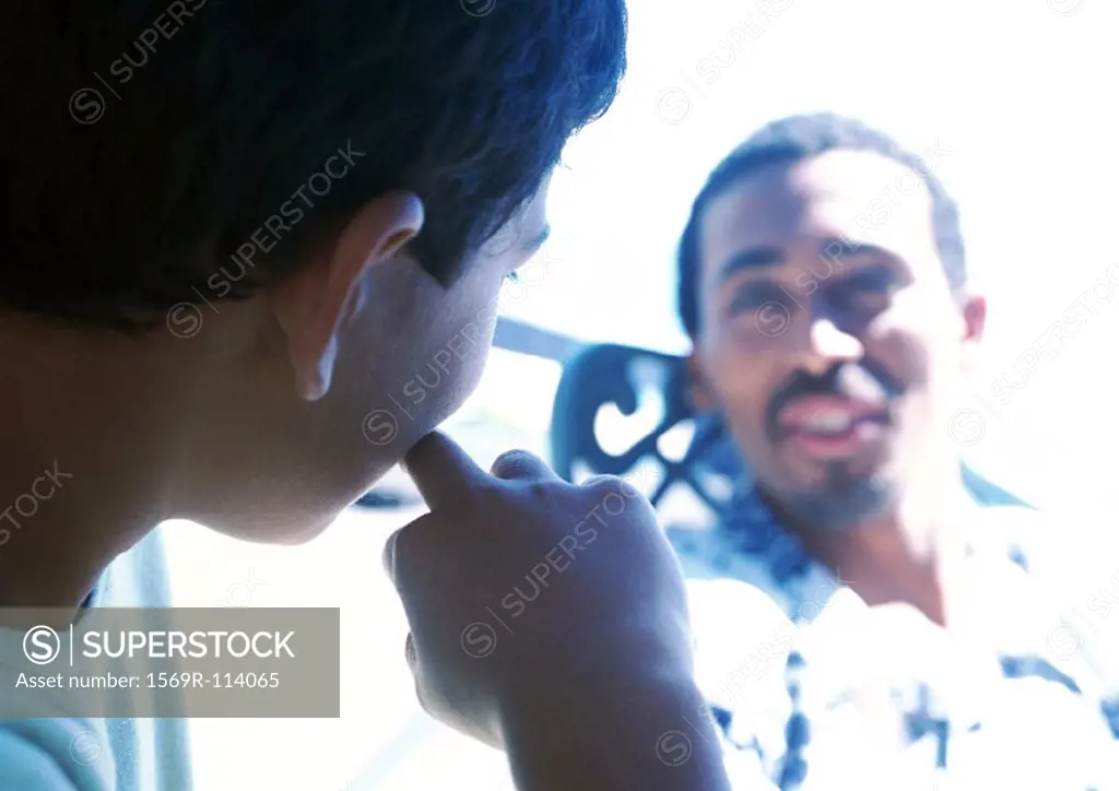 Man and boy talking, close-up