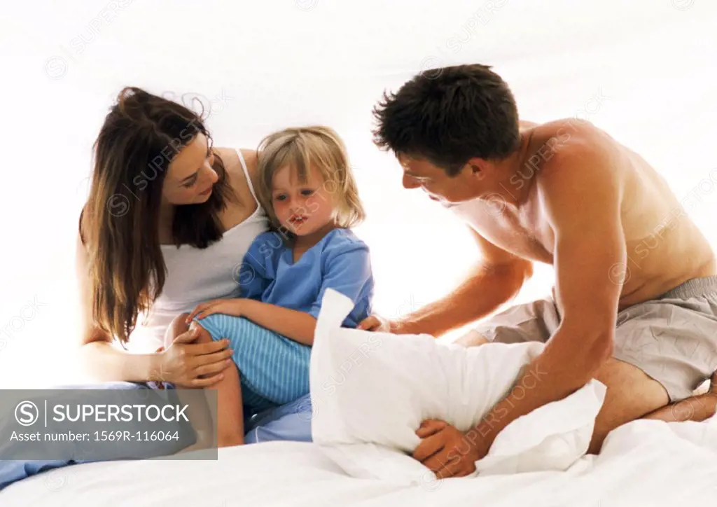 Couple and child on bed