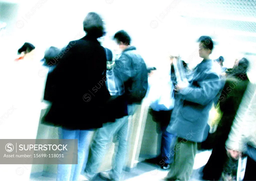 People standing in line, blurred