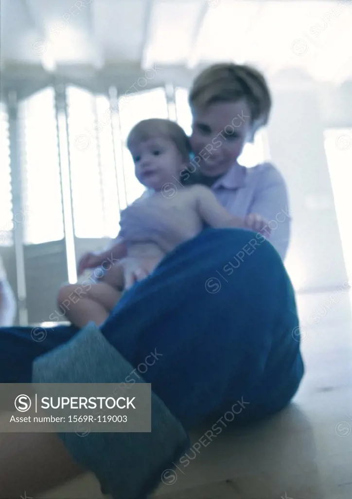 Woman holding baby, low angle view
