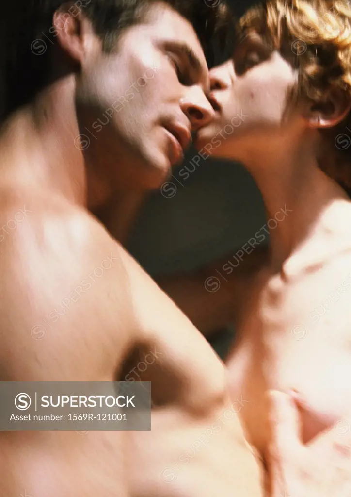 Nude couple embracing, close-up, blurred