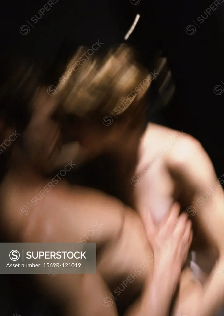Nude couple embracing, blurred motion