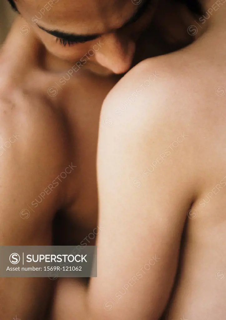 Nude couple embracing, close-up