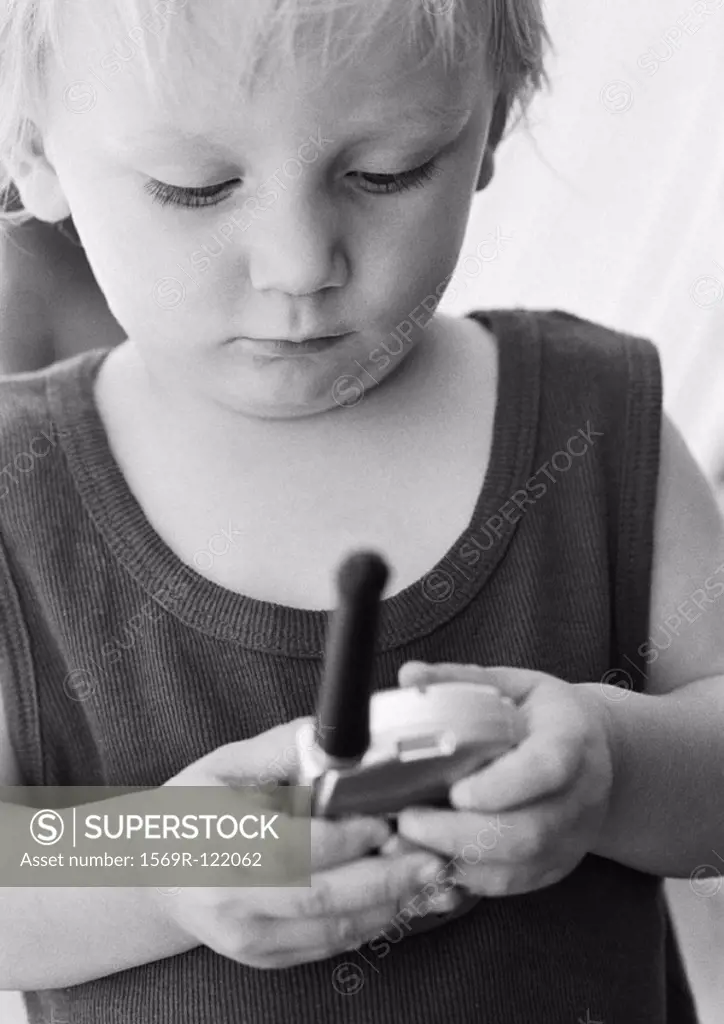 Child looking at phone, close-up, b&w