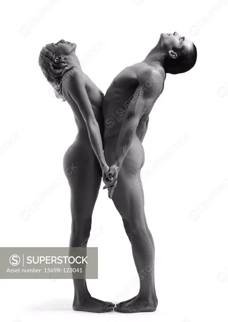 Nude man and woman standiing toe to toe with stomachs together and heads back, b&w