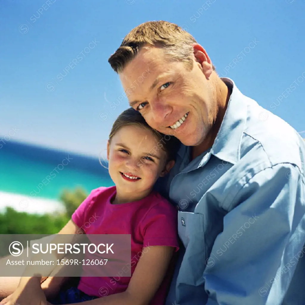 Mature man and daughter sitting outside, portrait