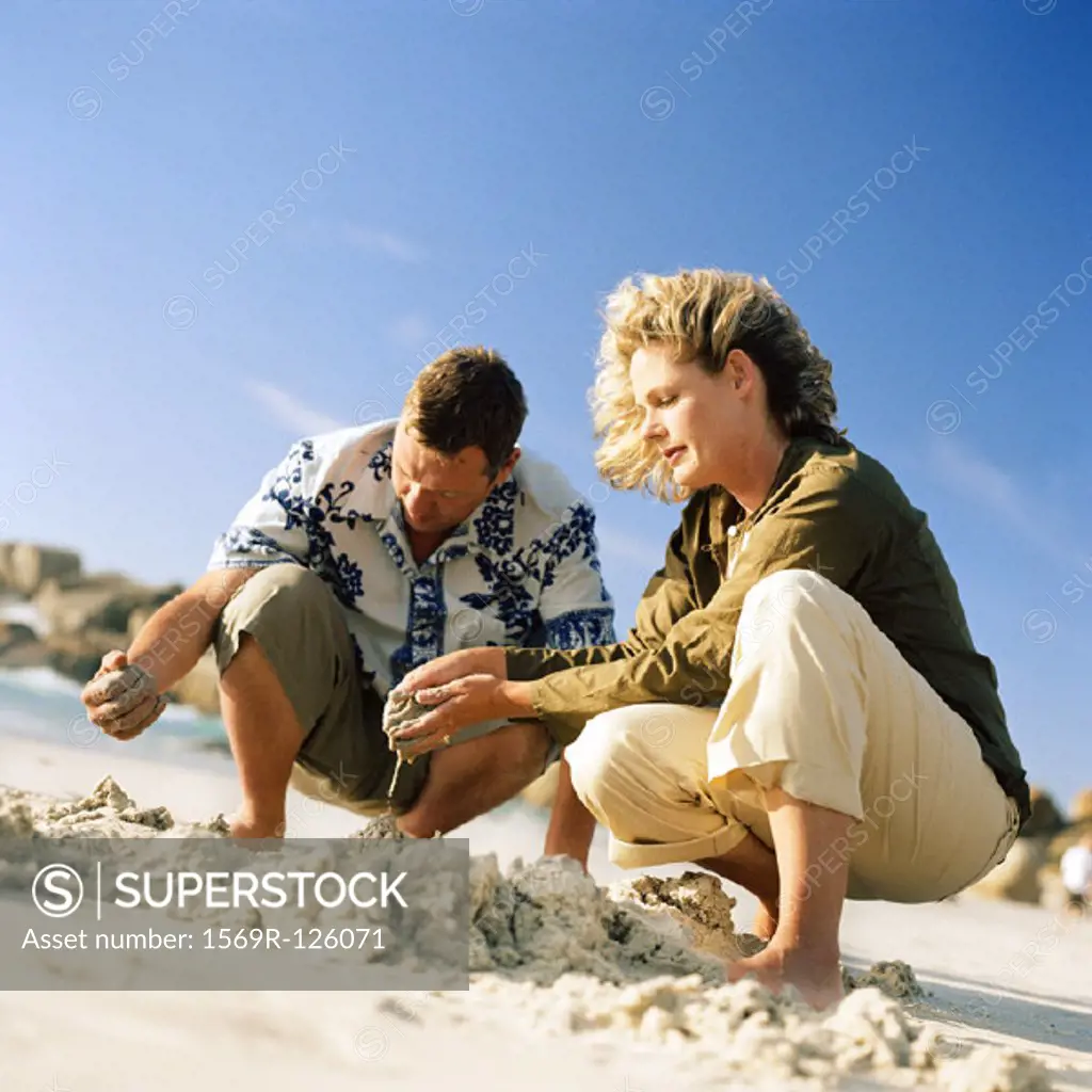 Couple digging in sand