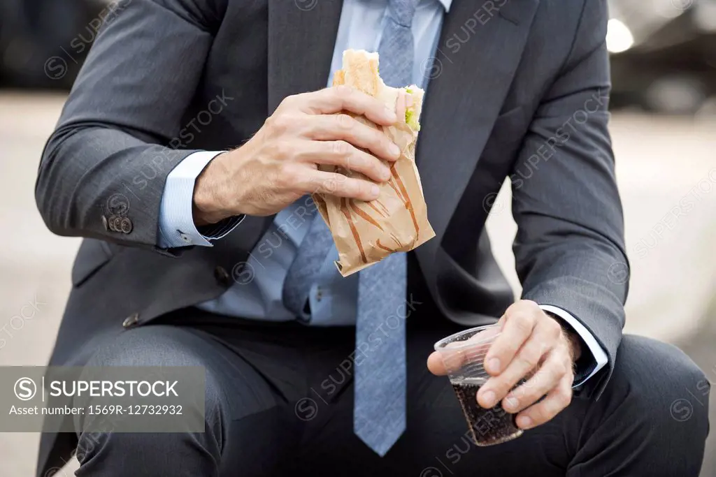 Office worker having lunch outdoors
