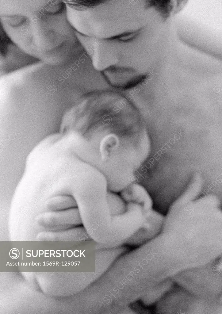 Mother and father with sleeping infant, b&w