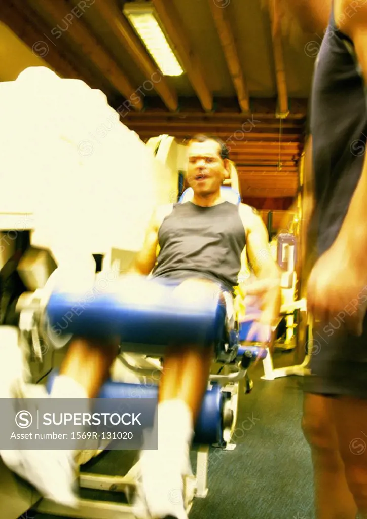 Man using weight machine in gym