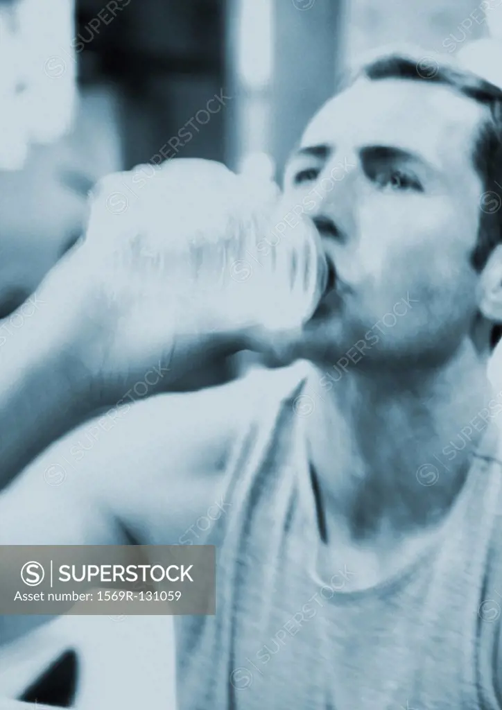 Man drinking from bottle of water