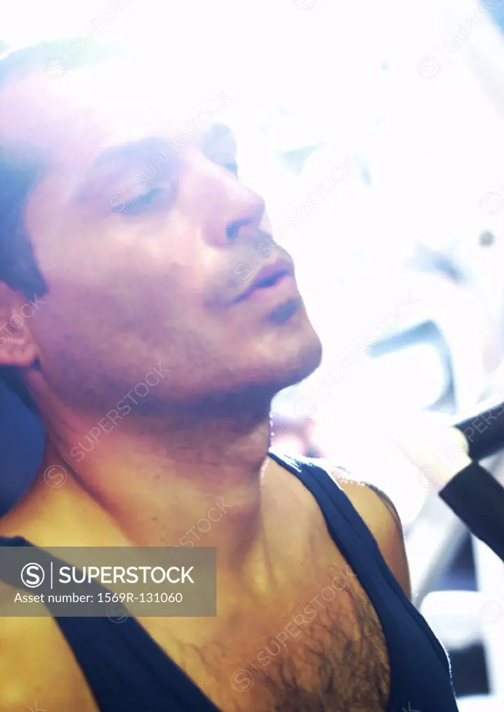Man taking breath in gym, close-up