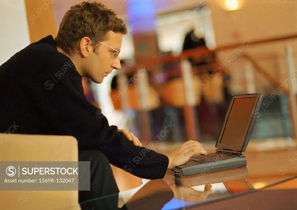 Man using laptop, side view
