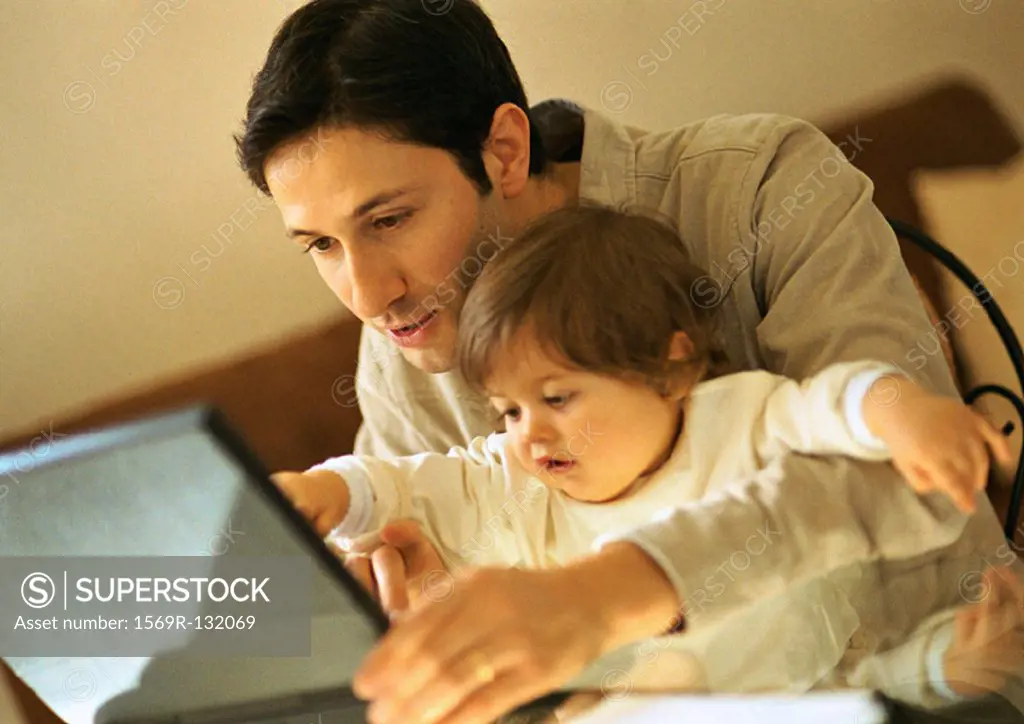 Father and baby using laptop