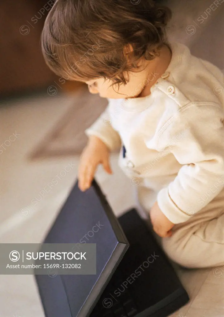 Baby with laptop, portrait