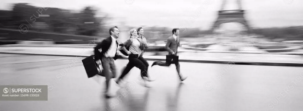 Business people running across esplanade in front of Eiffel Tower, b&w, panoramic view
