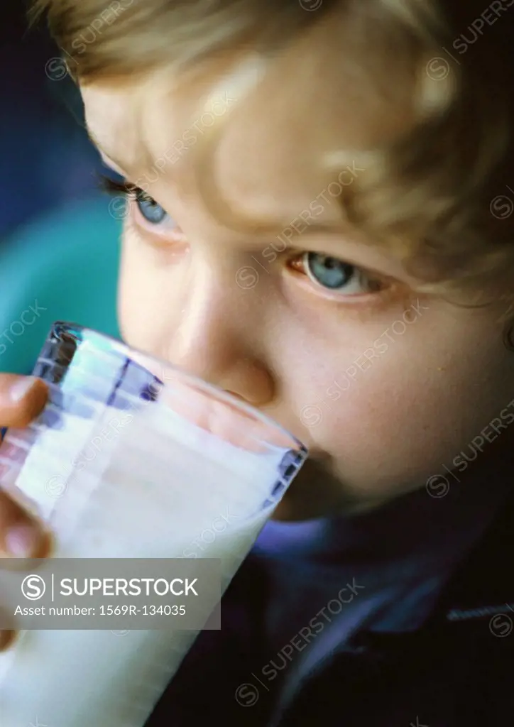 Child drinking from glass, close-up