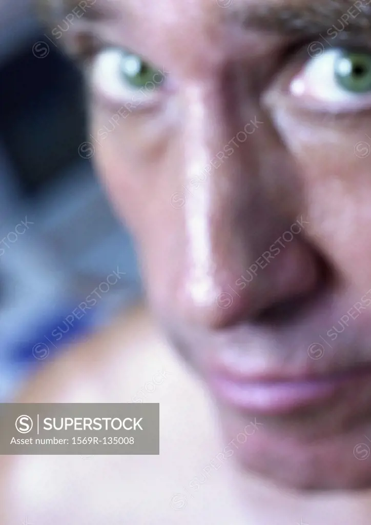 Mature man looking up at camera, close-up, portrait