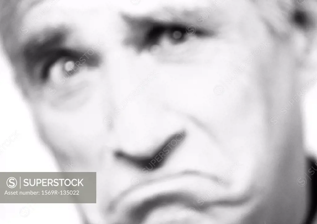Mature man frowning, close-up, portrait, blurred, b&w