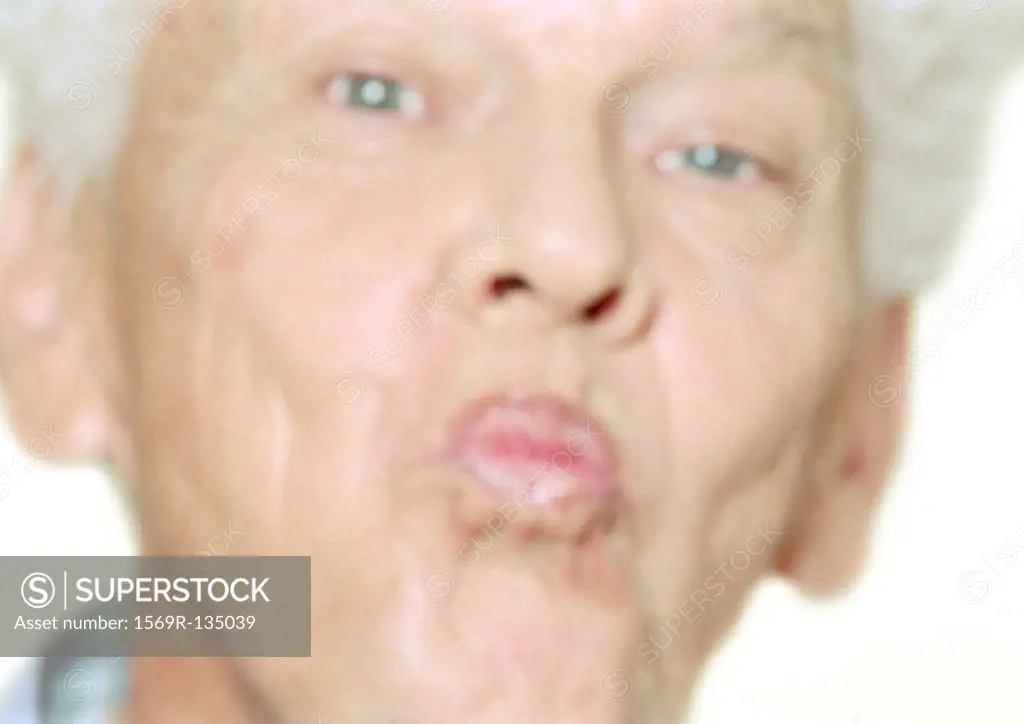 Senior man puckering lips, close-up, portrait